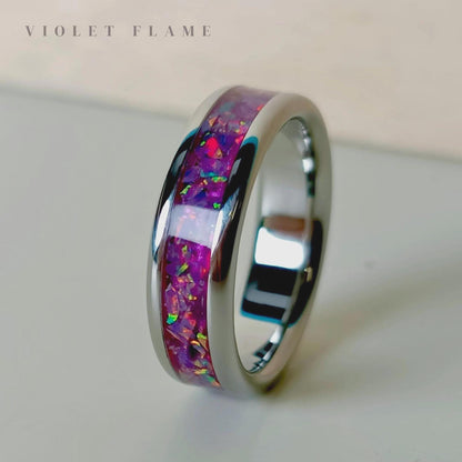 Ring with colorful inlay on a light background, branded 'Violet Flame'.